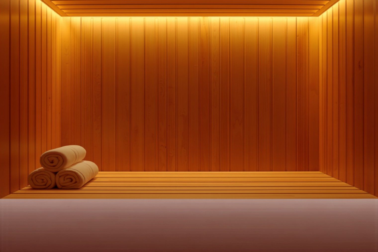 Warm timber interior of an infrared sauna with rolled towels