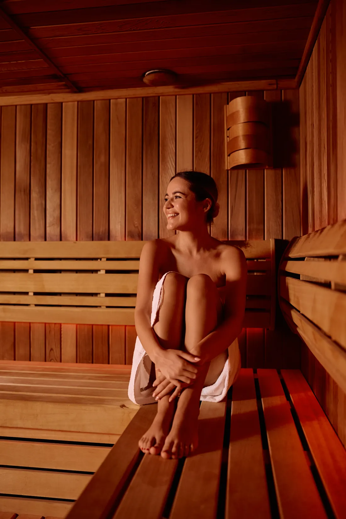 Woman relaxing in an infrared sauna at Full Circle Health
